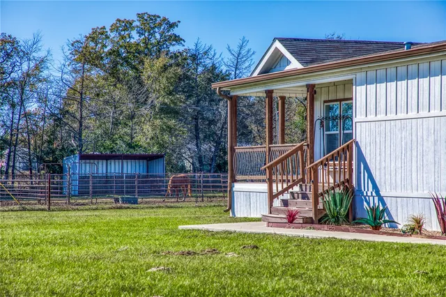 a kitchen with stainless steel appliances a dining table chairs sink and wooden floor