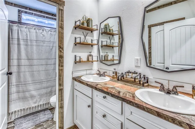 a view of a swimming pool with a table and chairs under an umbrella