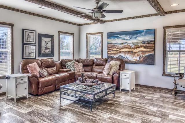 a living room with furniture and a floor to ceiling window