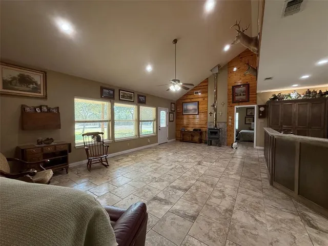 a living room with furniture a large window and a chandelier