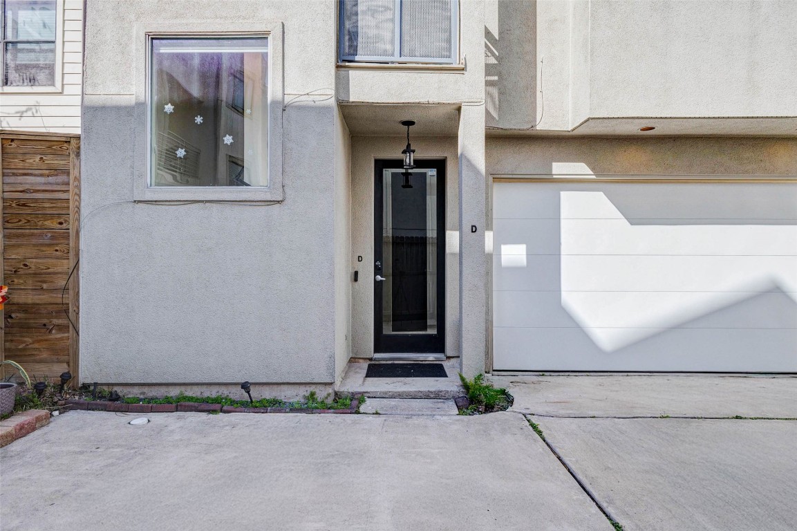 5715 Larkin Street, Unit D Houston, TX 77007 - Photo 2 of 38 Welcoming entry with contemporary finishes and high ceilings that immediately set the tone for the home’s modern design. Natural light filters through the glass-accented front door, while durable flooring provides both style and function. A thoughtful layout separates the first-floor suite from the main living areas.