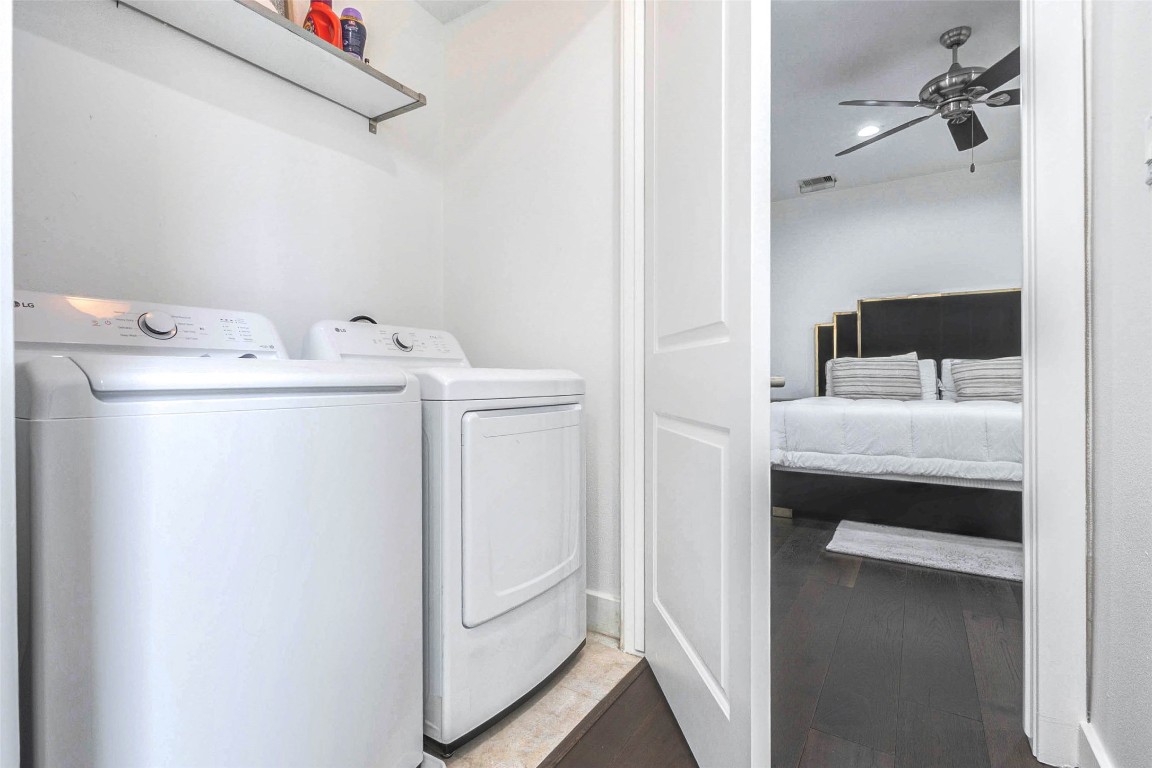 5715 Larkin Street, Unit D Houston, TX 77007 - Photo 24 of 38 Convenient upper-level utility room featuring full-size washer and dryer for everyday ease. Overhead shelving provides practical storage for laundry essentials, while the tucked-away location keeps household tasks discreetly separated from main living areas. Positioned near bedrooms for optimal functionality.