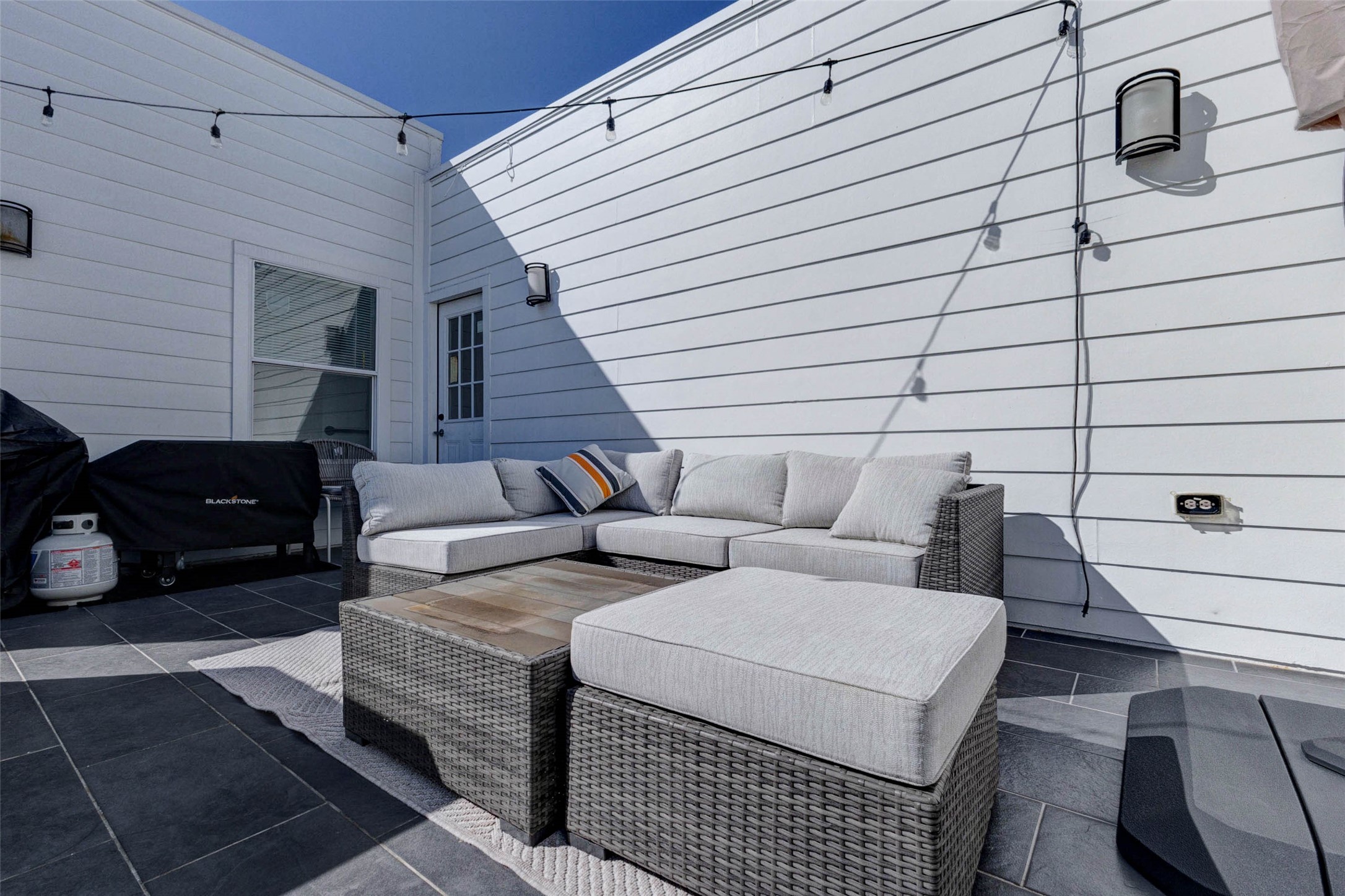 5715 Larkin Street, Unit D Houston, TX 77007 - Photo 28 of 38 Another angle of the rooftop terrace showcasing spacious seating arrangement and grill area for outdoor cooking. Generous square footage allows for both dining and lounging spaces, making this rooftop an ideal extension of the home’s living areas.