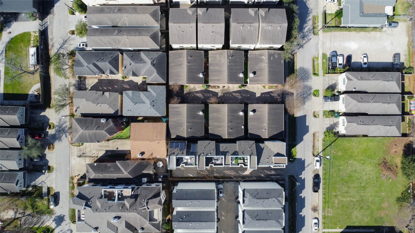 5715 Larkin Street, Unit D Houston, TX 77007 - Photo 34 of 38 Wide aerial view of the contemporary townhome community and surrounding residential streets. The home’s location within Cottage Grove provides quick access to Downtown, the Galleria, Hike & Bike Trails and nearby parks while maintaining a neighborhood feel.
