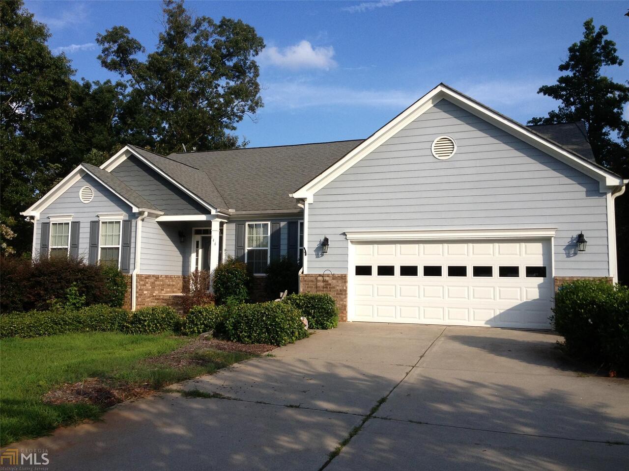 146 Rambler Inn Road, Unit 4 Jefferson, GA 30549 - Photo 1 of 1 a front view of a house with a yard and garage