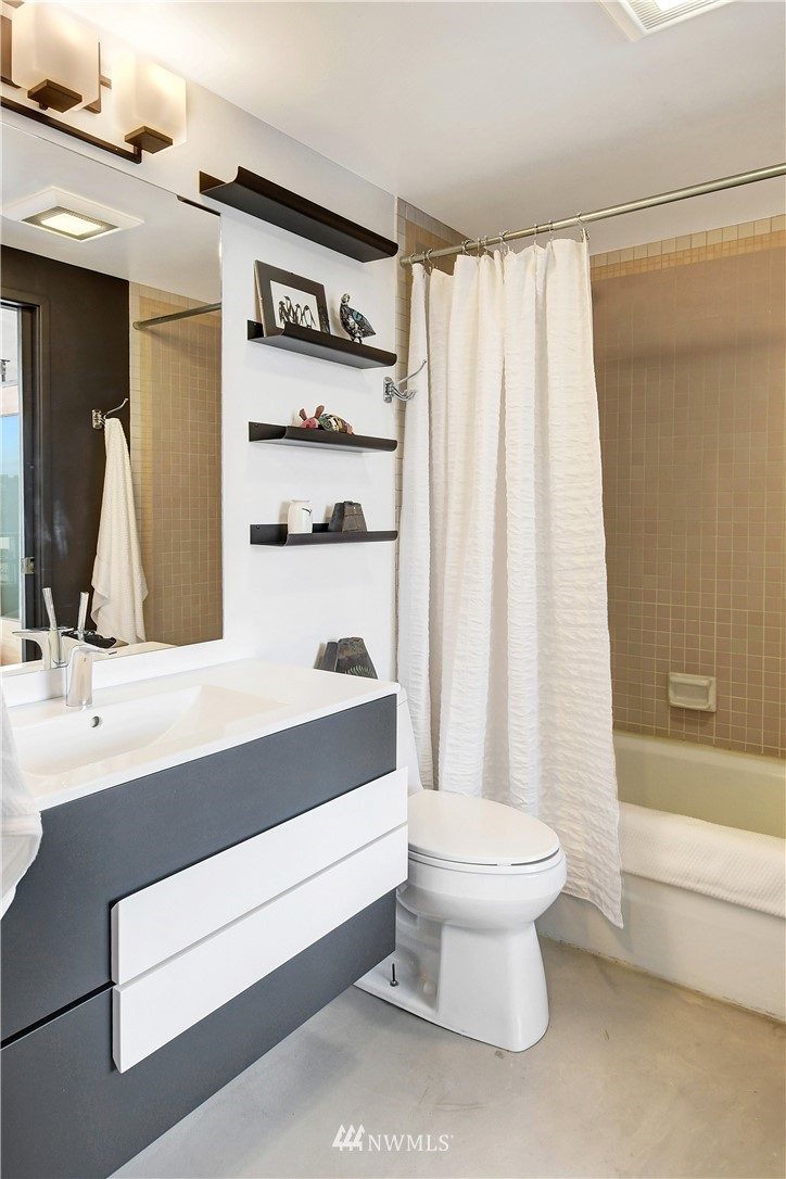 2125 1st Avenue, Unit 1102 Seattle, WA 98121 - Photo 14 of 34 a bathroom with a sink a toilet and a bathtub