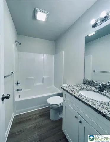a bathroom with a bathtub and shower