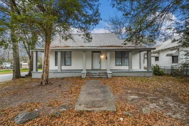 a house with trees in the background