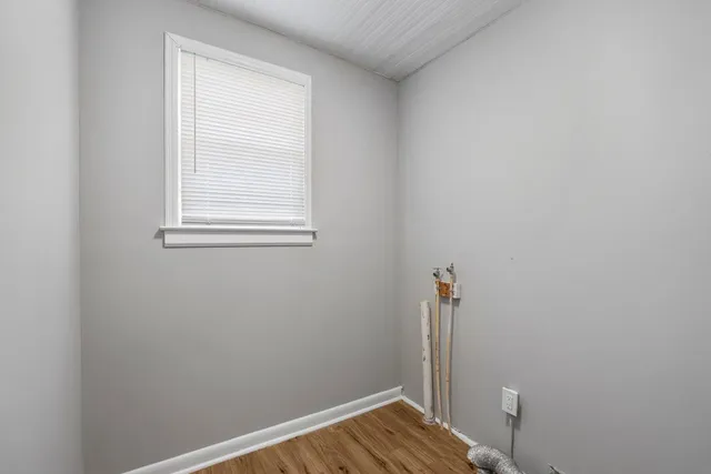 a view of room with window and wooden floor