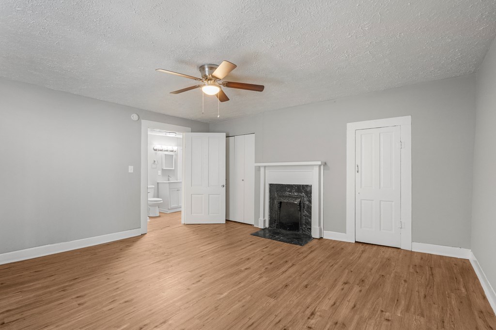 1301 20th Street Columbus, GA 31901 - Photo 8 of 16 a view of empty room with wooden floor and fireplace