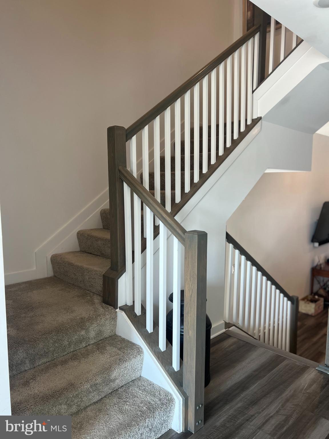 738-7 Tatum Court Frederick, MD 21702 - Photo 11 of 19 a view of staircase with lots of frames on wall and wooden floor