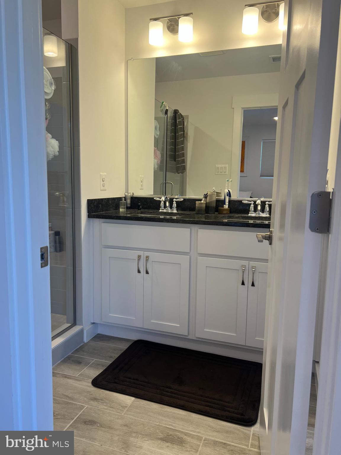 738-7 Tatum Court Frederick, MD 21702 - Photo 13 of 19 a bathroom with a sink and a mirror