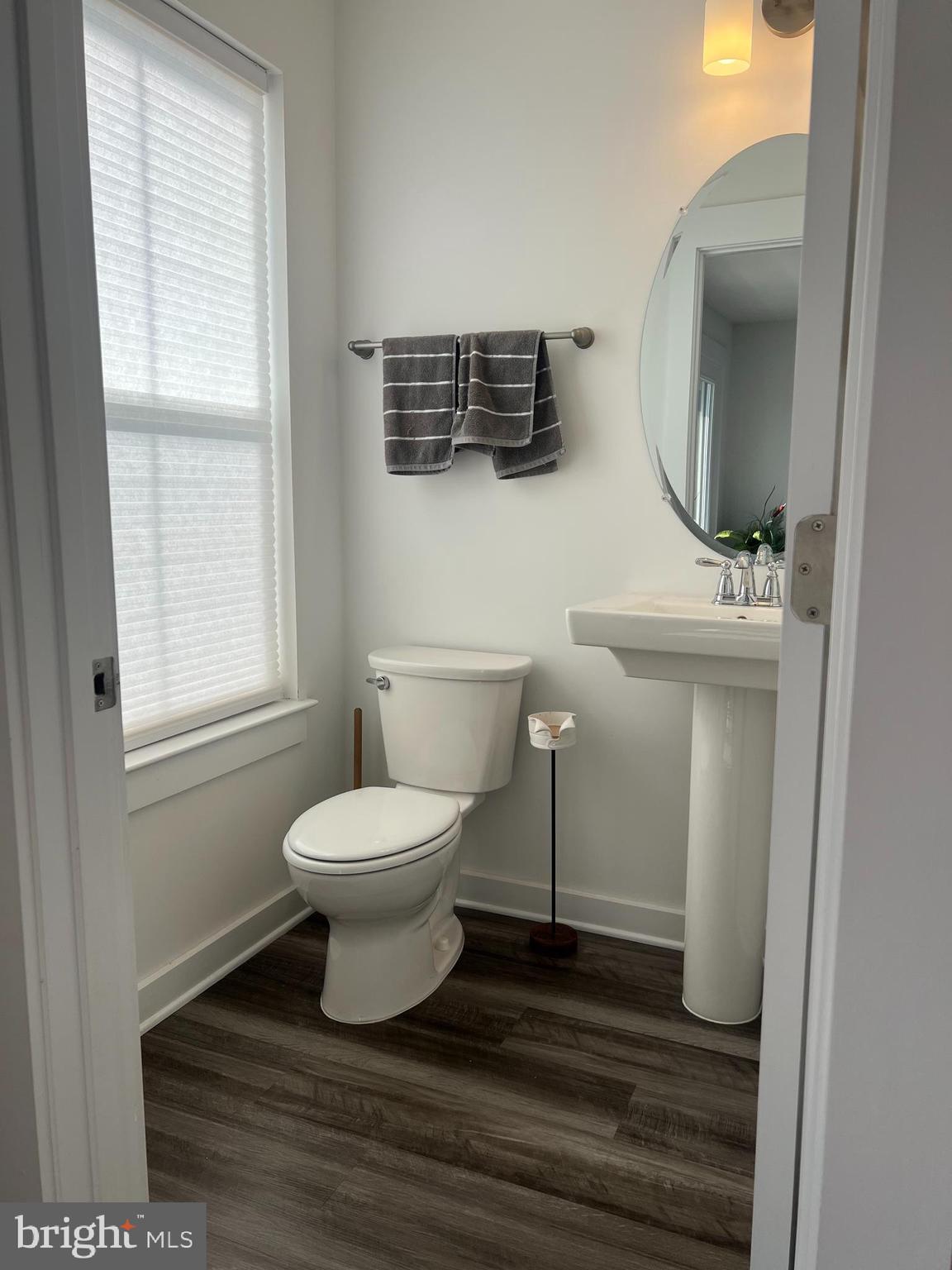738-7 Tatum Court Frederick, MD 21702 - Photo 10 of 19 a bathroom with a toilet a sink and mirror