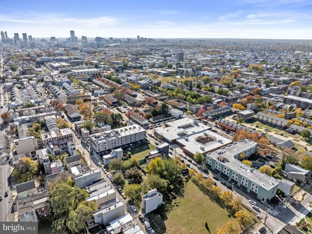 a aerial view of multi story residential apartment building with yard
