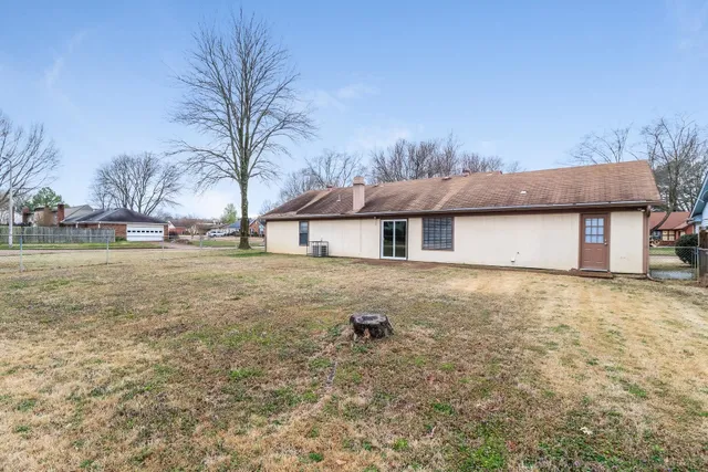 a backyard of a house with table and chairs