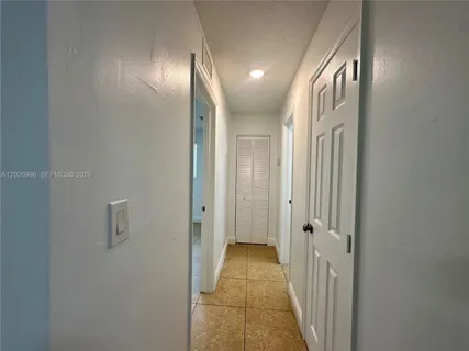 a small space with a wooden floor and a window