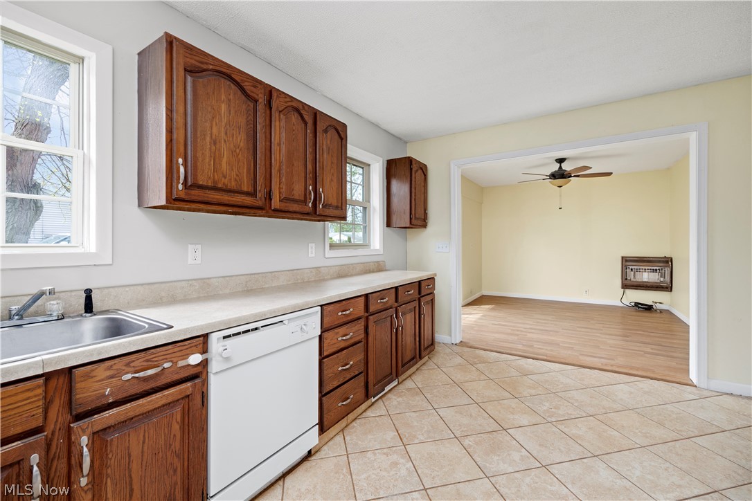 34067 Bainbridge Road North Ridgeville, OH 44039 - Photo 13 of 33 Kitchen with sink, ceiling fan, white dishwasher, and light tile floors