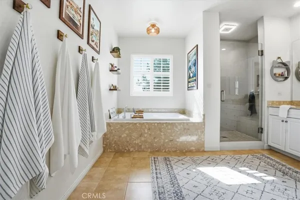 a view of a bathroom with bathtub and shower