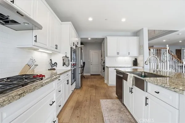 a kitchen with stainless steel appliances a stove and cabinets
