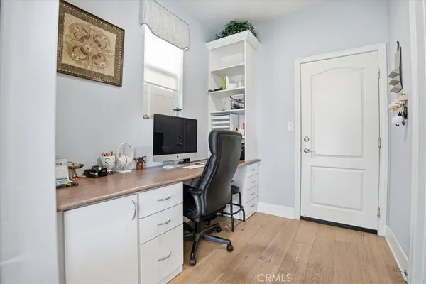 a view of a workspace with furniture and a window