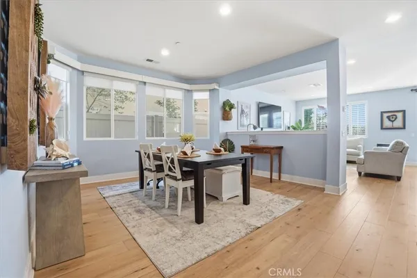 a view of a dining room with furniture and a large window