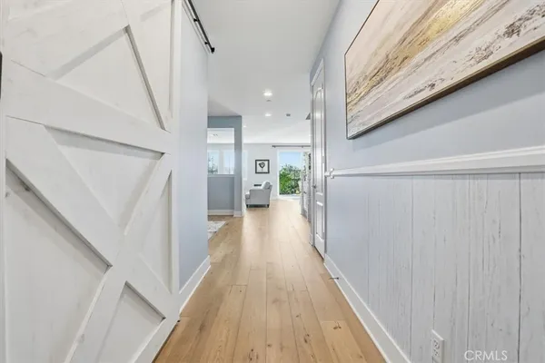 a view of a hallway with wooden floor and staircase