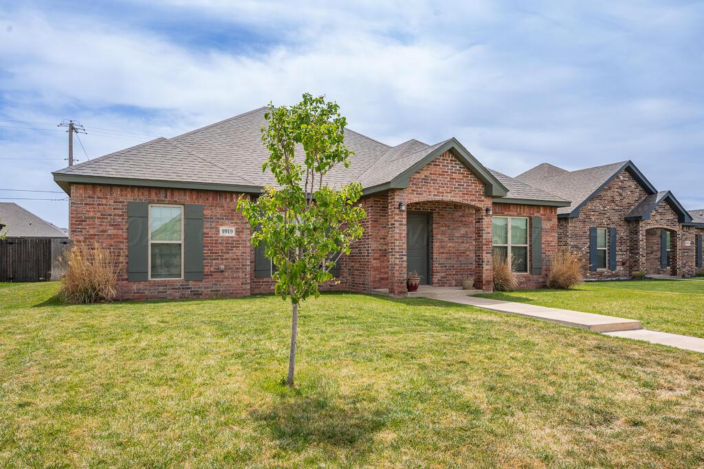 9919 Addelyn Avenue Amarillo, TX 79119 - Photo 3 of 23 a front view of a house with a yard and garage