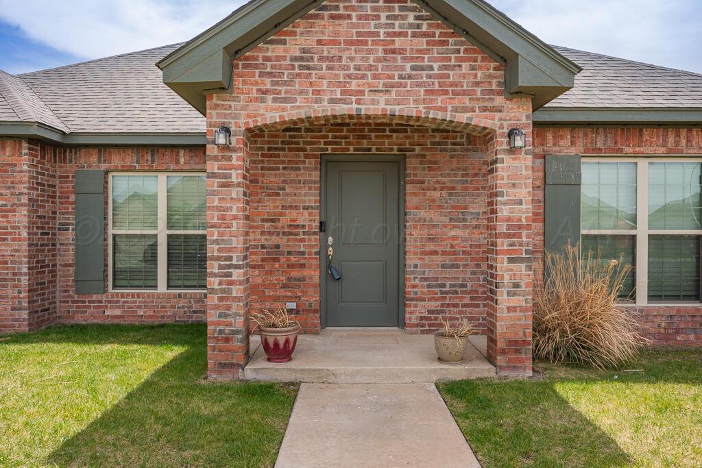 9919 Addelyn Avenue Amarillo, TX 79119 - Photo 4 of 23 a front view of a house with a garden