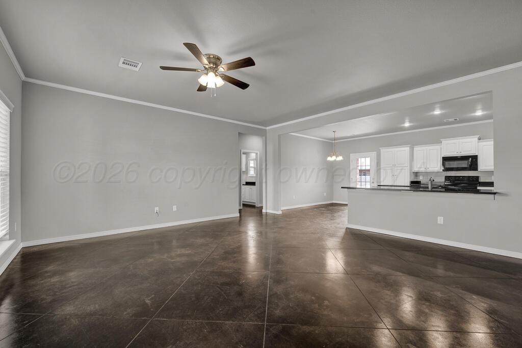9919 Addelyn Avenue Amarillo, TX 79119 - Photo 5 of 23 a view of an empty room with kitchen view and a window