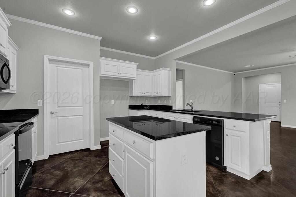 9919 Addelyn Avenue Amarillo, TX 79119 - Photo 8 of 23 a kitchen with a sink and cabinets