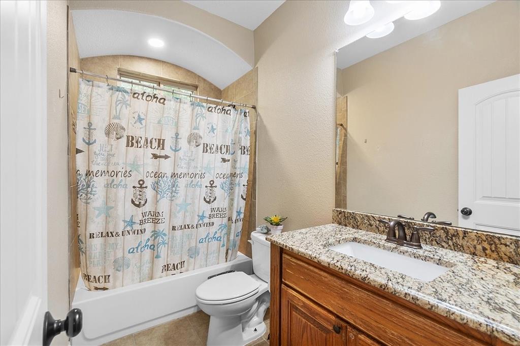502 Ritchey Street Gainesville, TX 76240 - Photo 7 of 29 a bathroom with a granite countertop sink toilet and shower