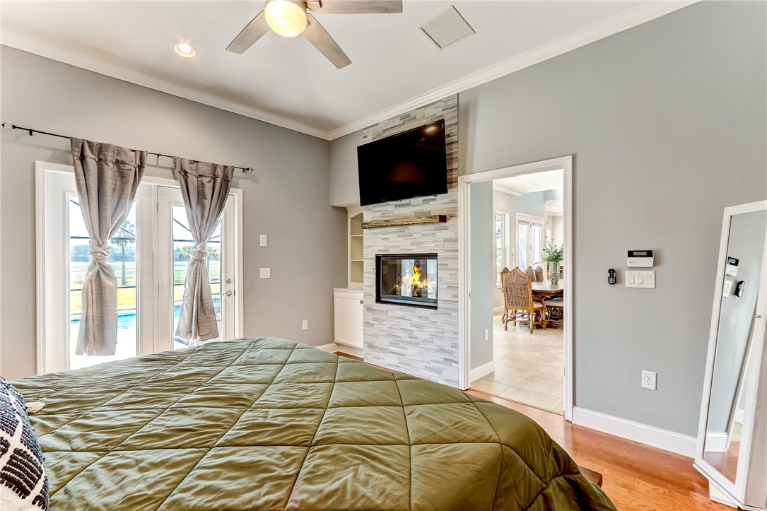 96266 Dowling Drive Yulee, FL 32097 - Photo 13 of 35 a bedroom with a large bed and a flat tv screen