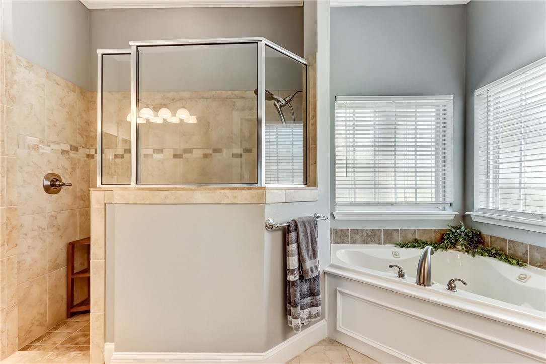 96266 Dowling Drive Yulee, FL 32097 - Photo 14 of 35 a bathroom with a bathtub and a shower