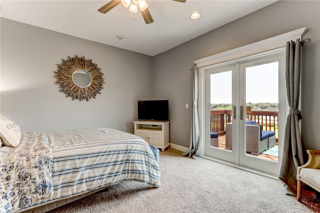 96266 Dowling Drive Yulee, FL 32097 - Photo 23 of 35 a bedroom with a bed and glass walk in closet