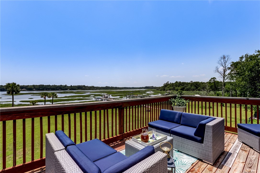 96266 Dowling Drive Yulee, FL 32097 - Photo 24 of 35 a view of a balcony with wooden floor and outdoor seating