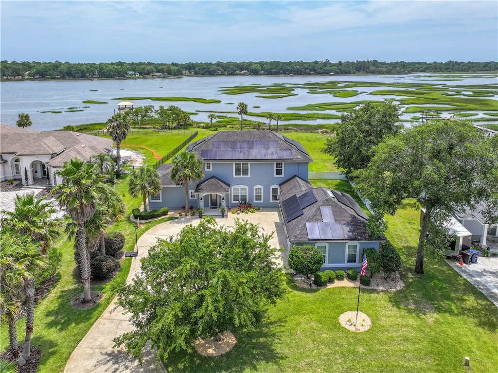 96266 Dowling Drive Yulee, FL 32097 - Photo 26 of 35 a view of a house with a swimming pool and a yard