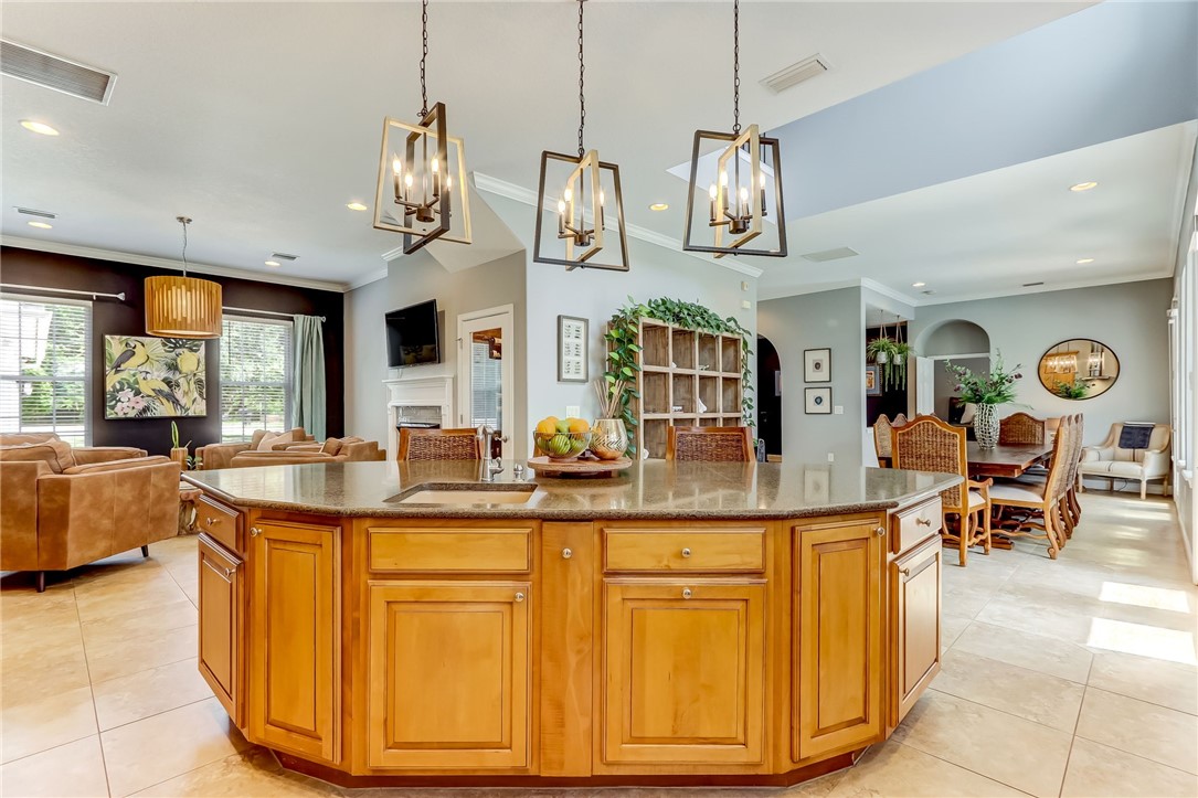 96266 Dowling Drive Yulee, FL 32097 - Photo 3 of 35 a dining hall with stainless steel appliances granite countertop a sink a kitchen island a stove and a wooden floors