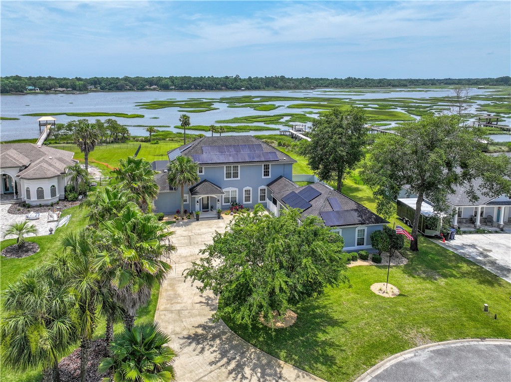 96266 Dowling Drive Yulee, FL 32097 - Photo 5 of 35 a view of a lake with a building in the background