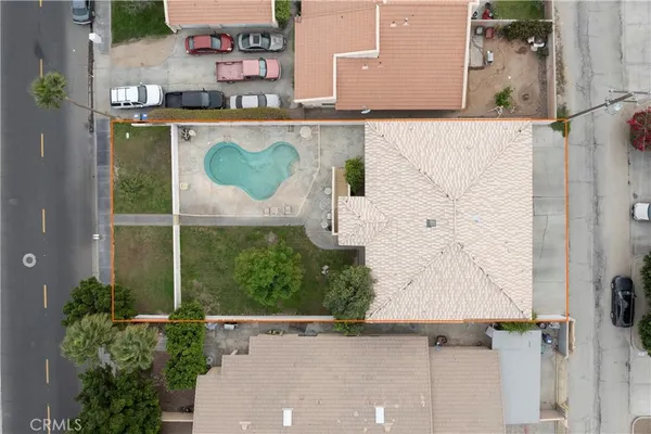 an aerial view of a house with a yard