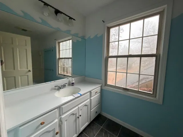 a bathroom with a sink and a window