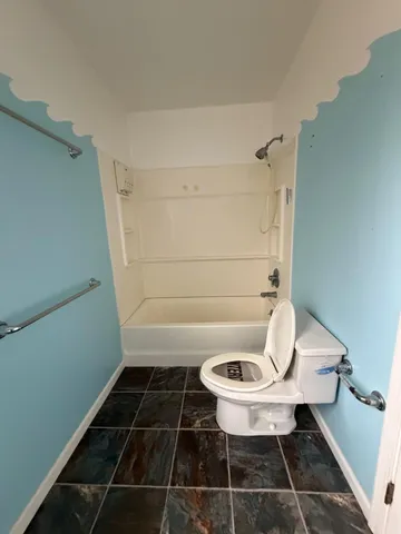 a bathroom with a toilet a sink and a shower