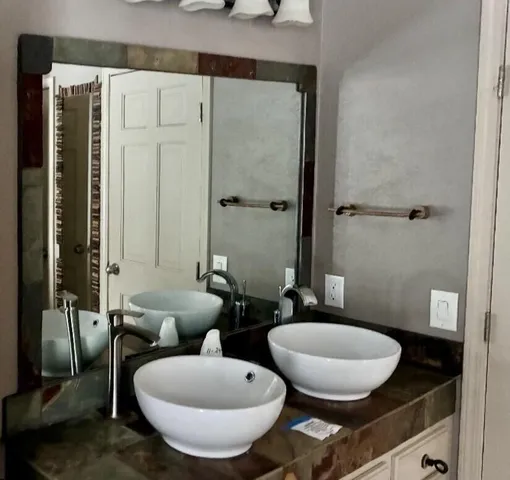 a bathroom with a toilet a sink and mirror