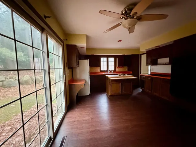 a view of kitchen with stainless steel appliances granite countertop a stove and a refrigerator