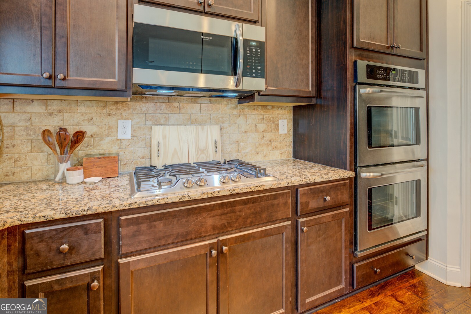 312 Relative Trail McDonough, GA 30253 - Photo 18 of 54 a kitchen with granite countertop a stove and a microwave