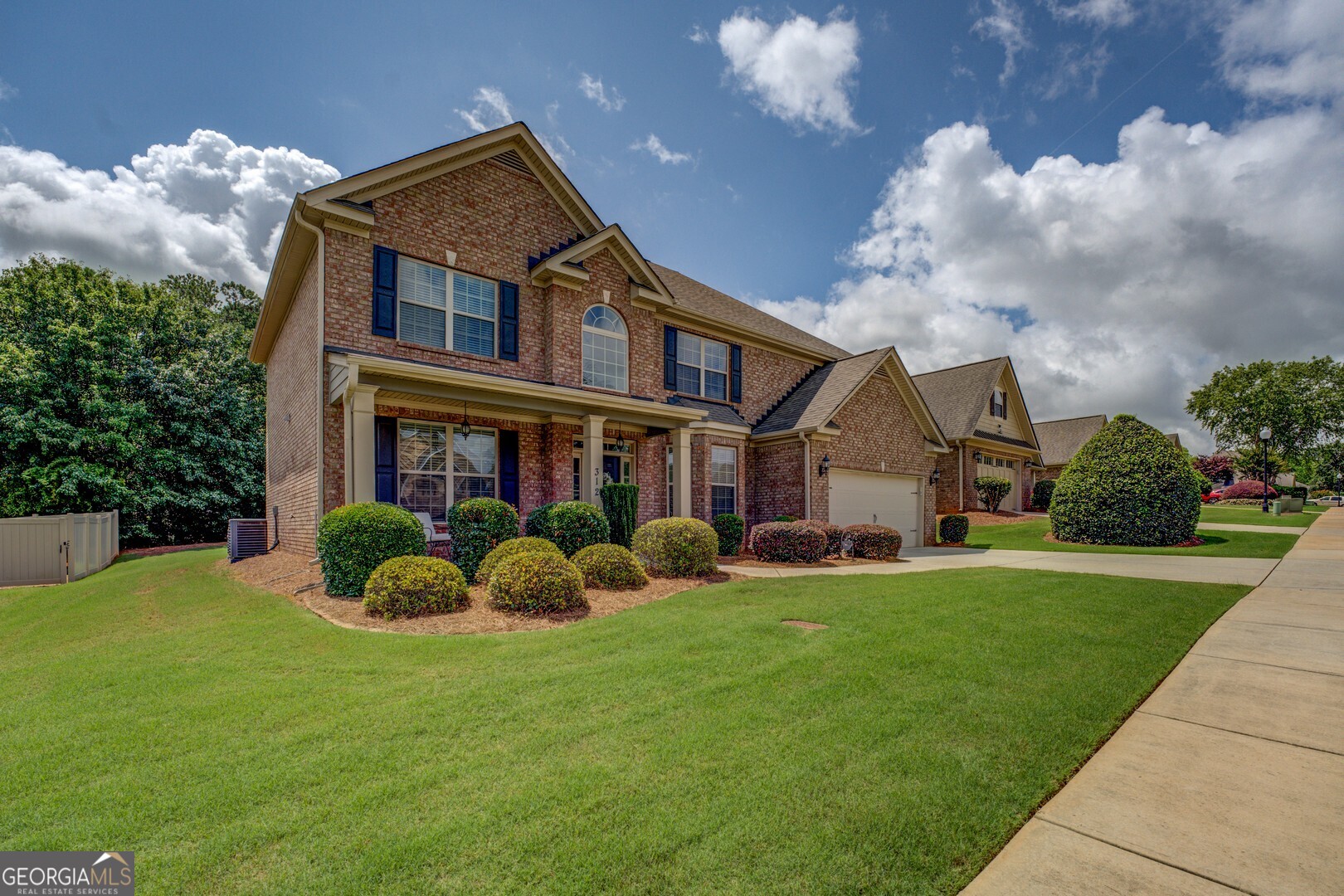 312 Relative Trail McDonough, GA 30253 - Photo 2 of 54 a front view of a house with a yard and trees