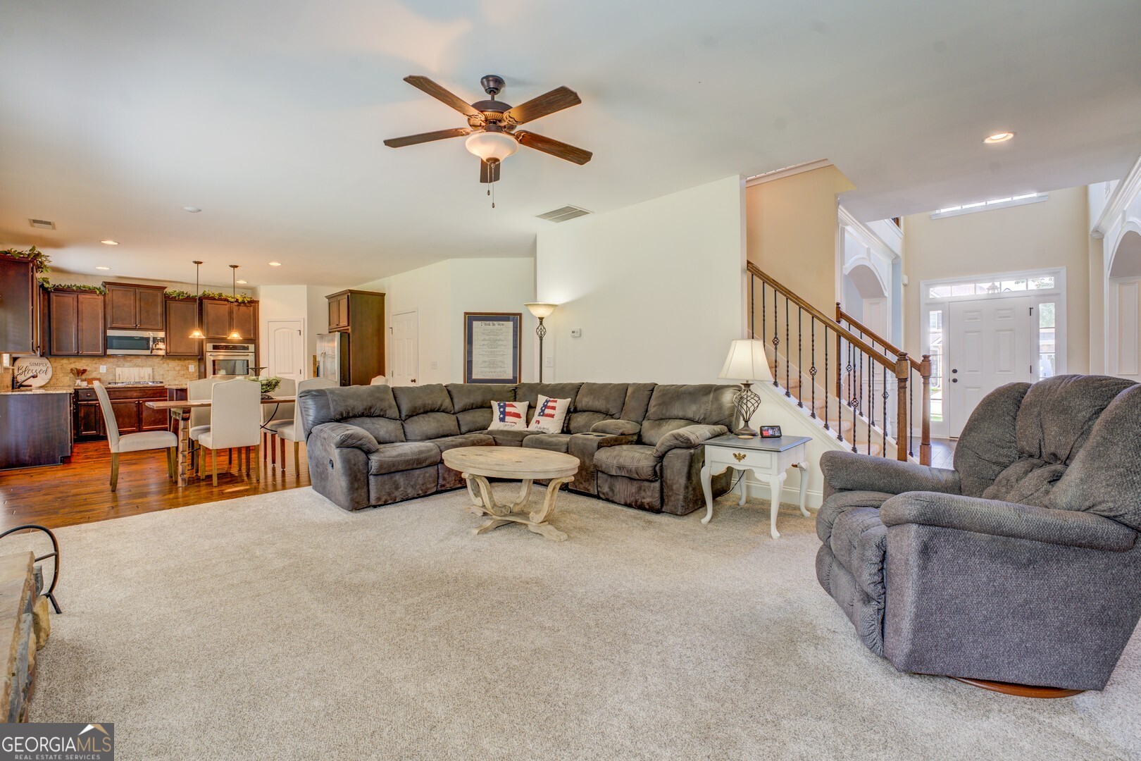 312 Relative Trail McDonough, GA 30253 - Photo 21 of 54 a living room with furniture kitchen view and a chandelier