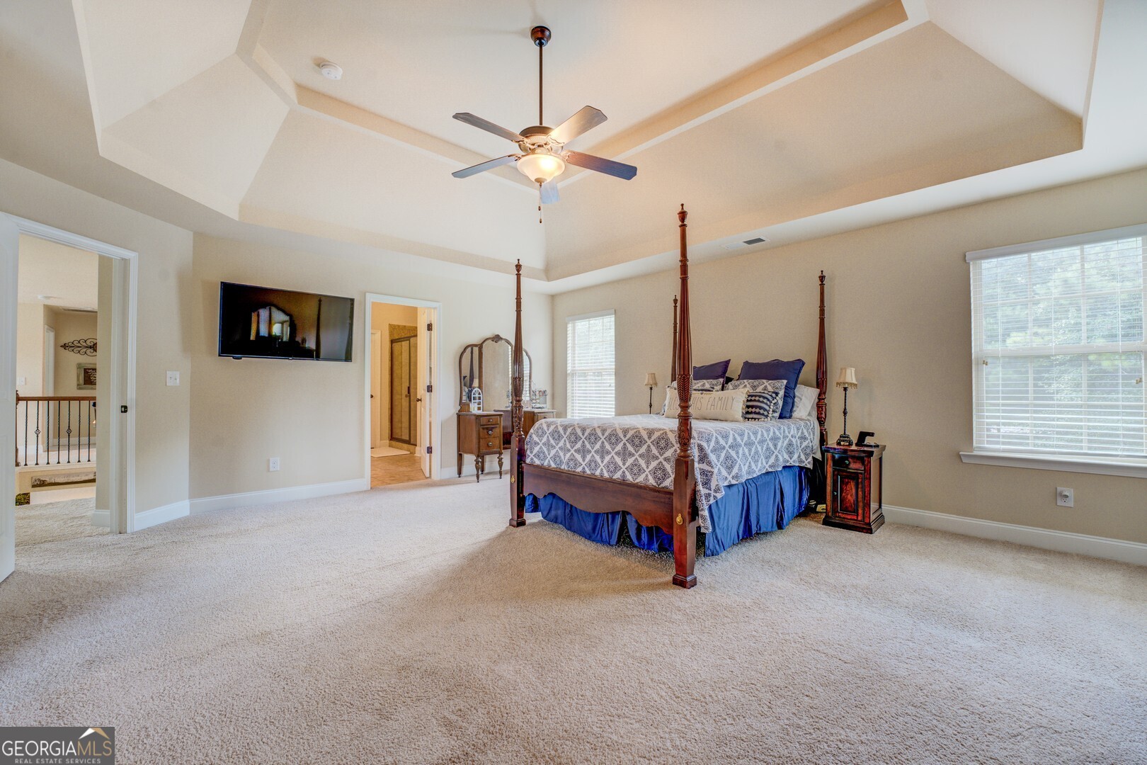 312 Relative Trail McDonough, GA 30253 - Photo 27 of 54 a spacious bedroom with a bed and a chandelier