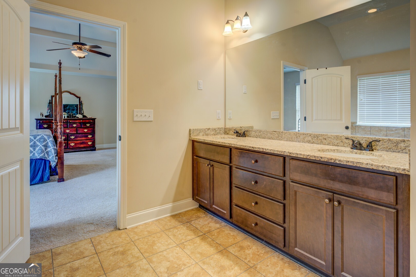 312 Relative Trail McDonough, GA 30253 - Photo 33 of 54 a spacious bathroom with a granite countertop sink and a mirror