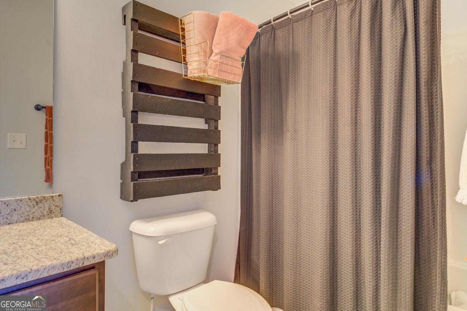 312 Relative Trail McDonough, GA 30253 - Photo 43 of 54 a bathroom with a toilet a sink and a shower curtain