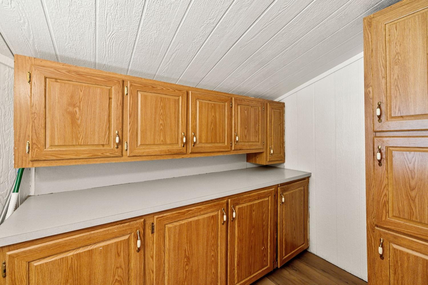 36696 Peterson Road Auberry, CA 93602 - Photo 13 of 34 a kitchen with wooden cabinets and a window